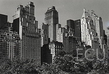 Black and white photo of Central Park South including images of classic New York City skyscrapers designed in the 1920s and 1930s