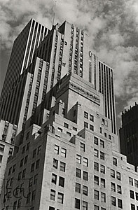 Black and white photo of Fifth Avenue in midtown showing the layers of architectural design that have accumulated over the decades in New York
