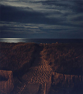 Color photo of Westhampton Beach taken at night on the ocean with a full moon