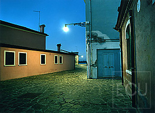 Color photo of a nocturnal view of a street on the island of Burano at dusk in Venice, Italy