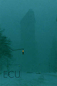 Color photo of the landmark Flatiron Building in snow taken from Fifth Avenue in New York, inspired by Edward Steichen's classic photograph