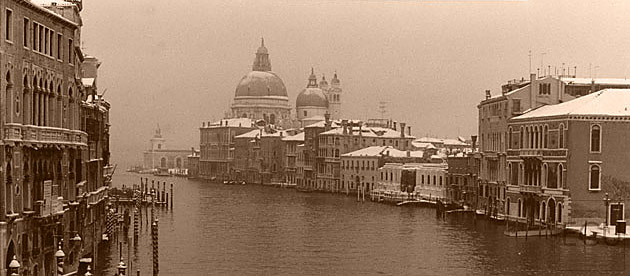 Sepia photograph of the Grand Canal in winter in snow in Venice from Ponte Accademia viewing the Santa Maria della Salute and Guggenheim