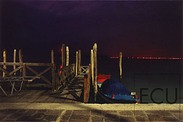 Color photograph of the Venetian Laguna at dusk from the Piazzale S. Maria Elisabetta facing the industrial lights of Porto Marghera, Italy