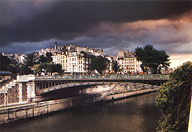 Color photograph of the Seine and the Pont au Double linking Cité and the Left Bank as a storm moved in over Paris, France