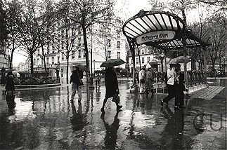 Paris metro Place des Abbesses in the rain in the 18th arrondisement, Paris, France