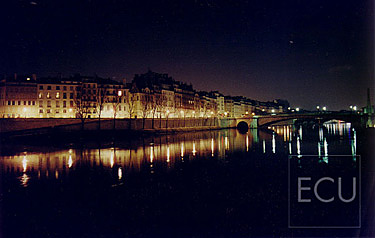 Color photograph of the Seine taken from the Parisian bridge Pont de l'Archevêché looking to Ile St. Louis in winter at night in Paris, France