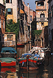 Color photo of a classic venetian canal Muneghette next to the Scuolo Grande di San Rocco in the San Polo sestiere of Venice, Italy