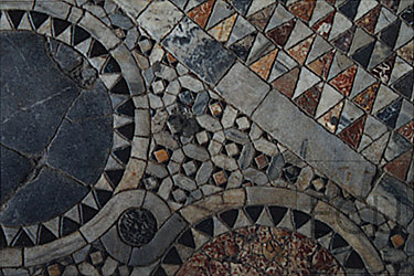 Color photograph of San Marco's tiles displaying modern, mosaic circles and triangles