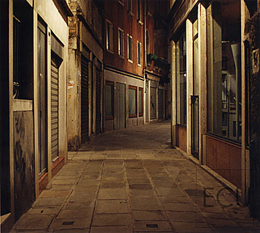 Color photo of a classic Venetian street scene near San Marco at night in Venice, Italy